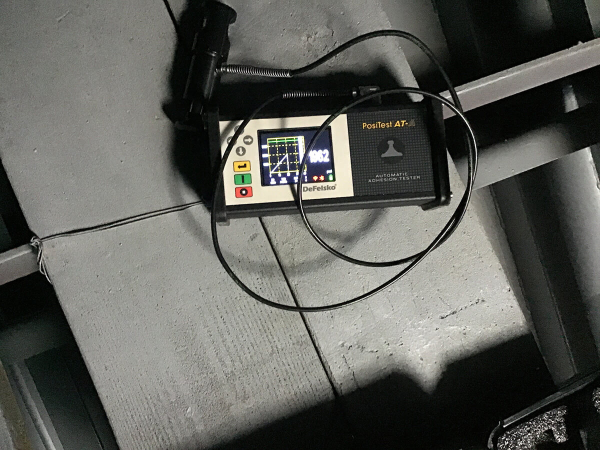 A PosiTest instrument shows an adhesion pull test result per ASTM D4541 of Carbomastic 15 of 1,962 psi (12,679.5 kPa).