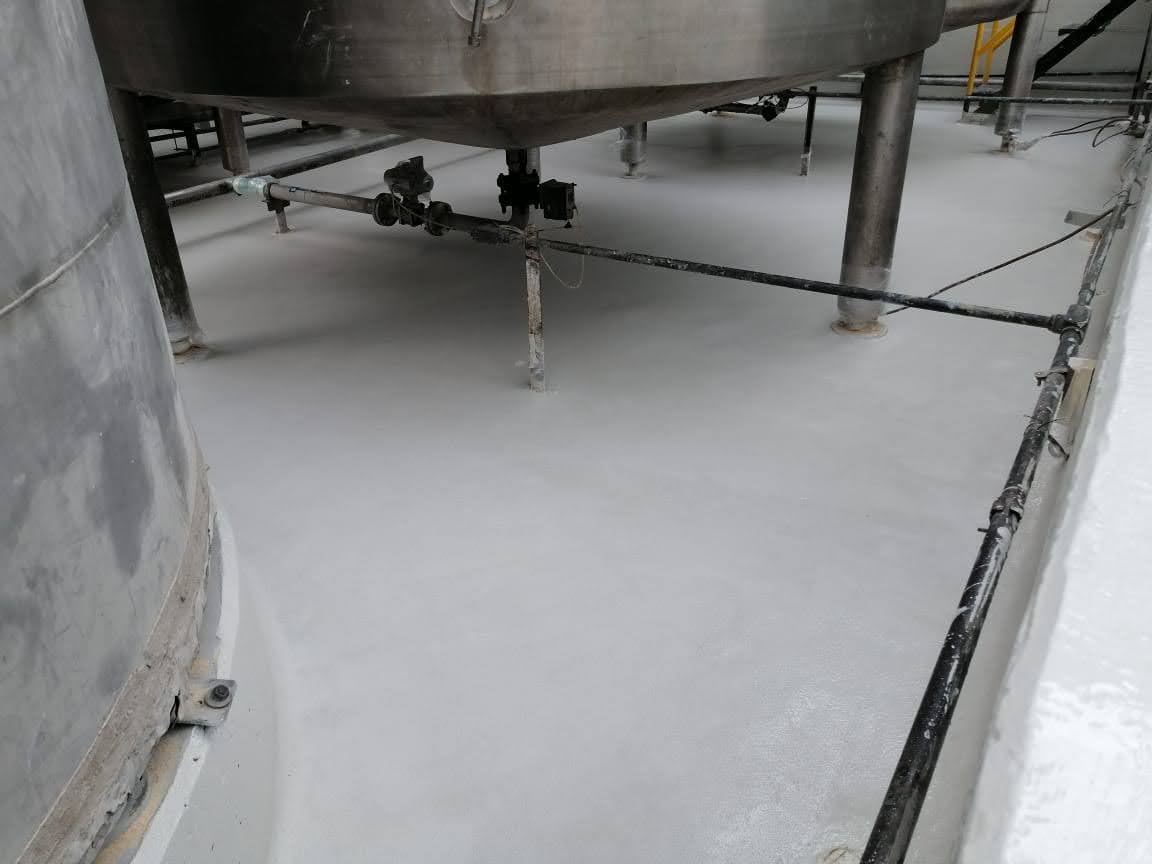  hemical-resistant floor coating protecting a concrete secondary containment area beneath process equipment.