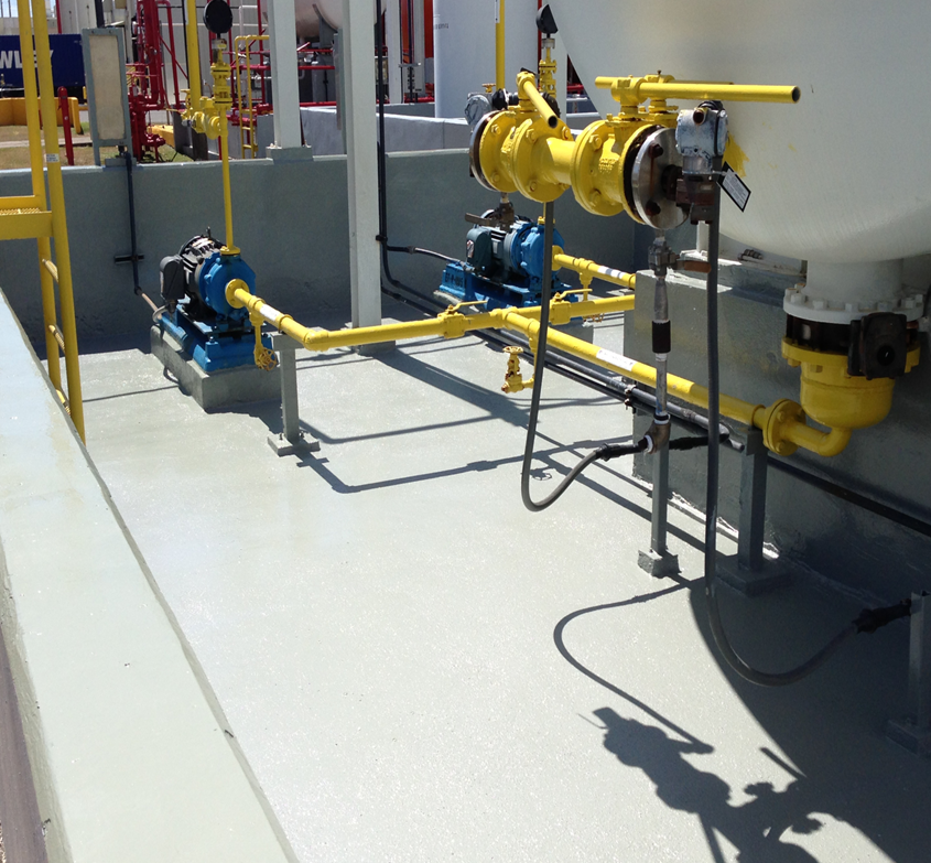 Secondary containment floor coating protecting pumps, piping, and storage tank equipment in an industrial process area.